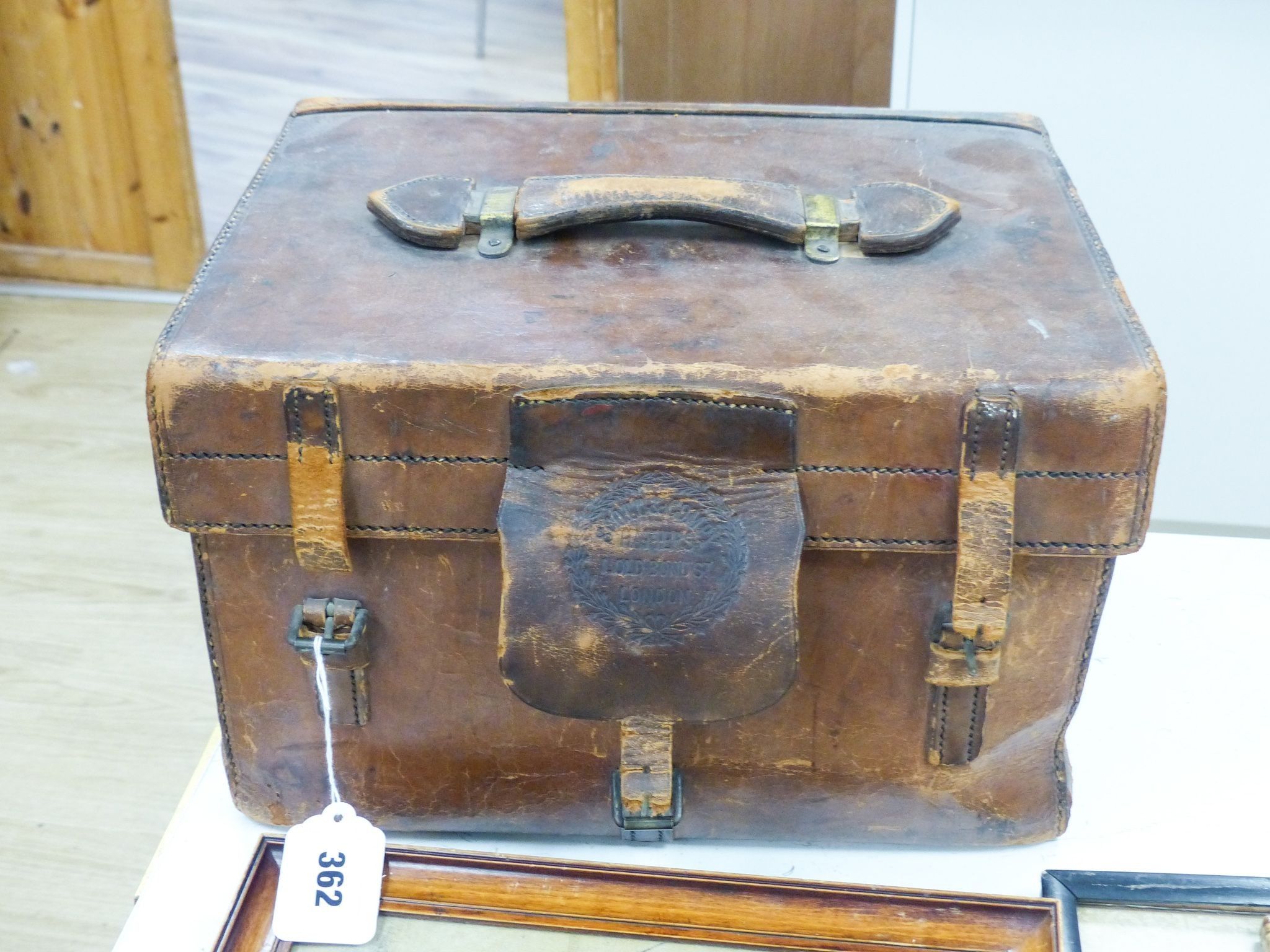 A Scott & Company brown leather case containing a grey top hat